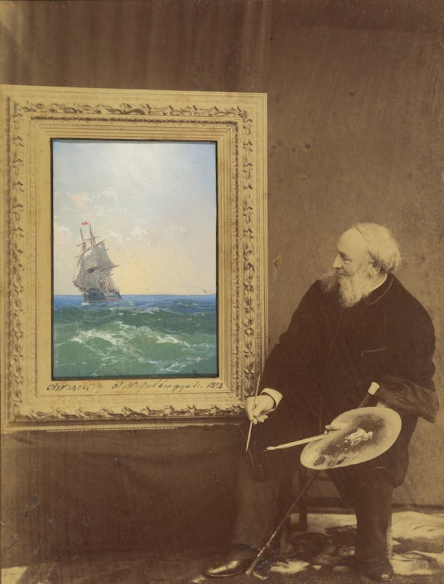 Photograph with artist before painted canvas