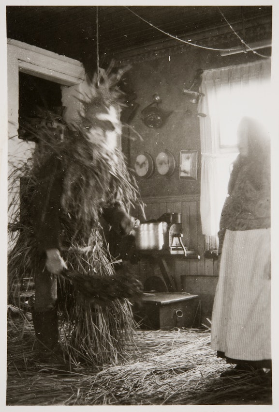 Photograph of a figure covered in straw