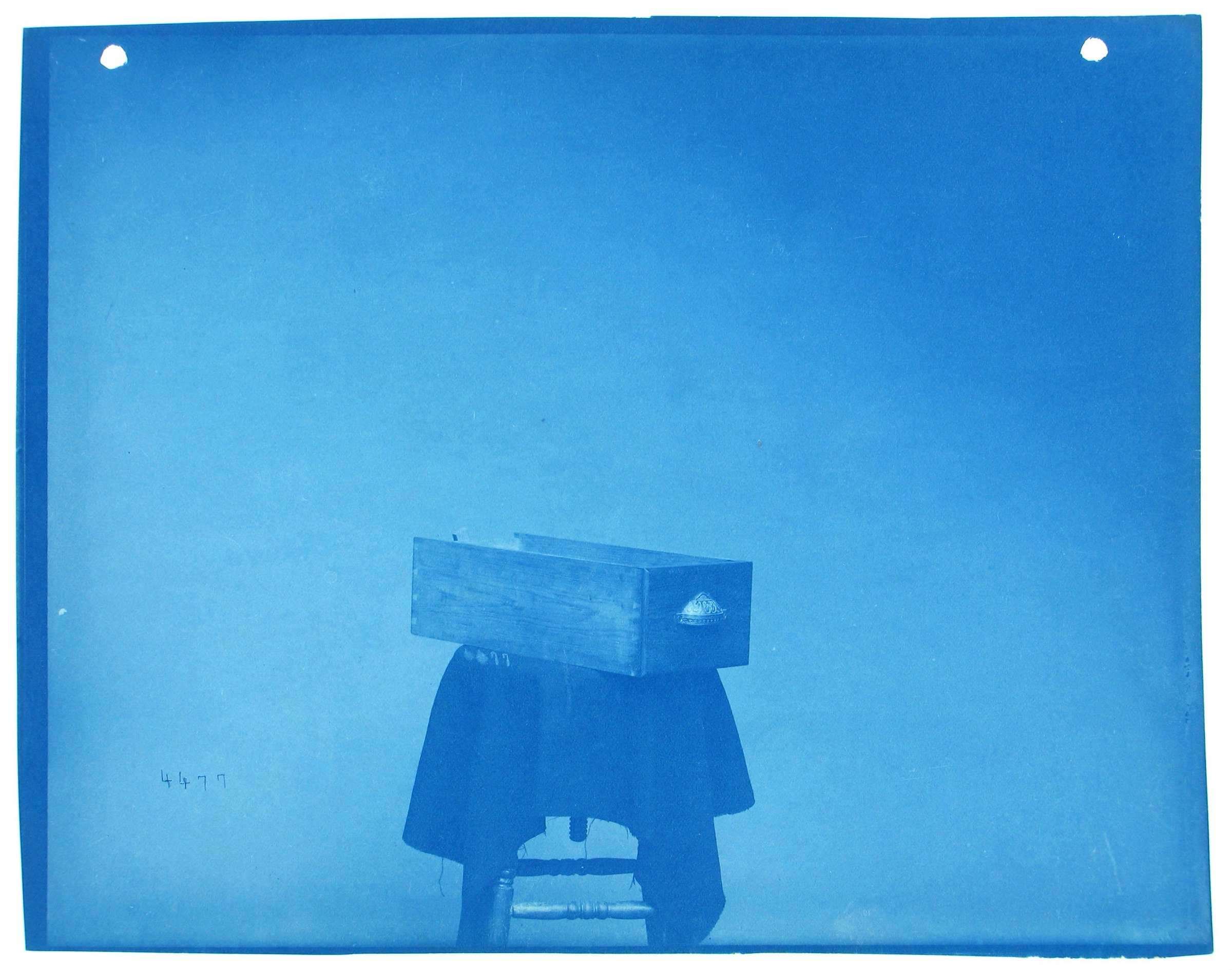 Blue photograph of drawer on pedestal.