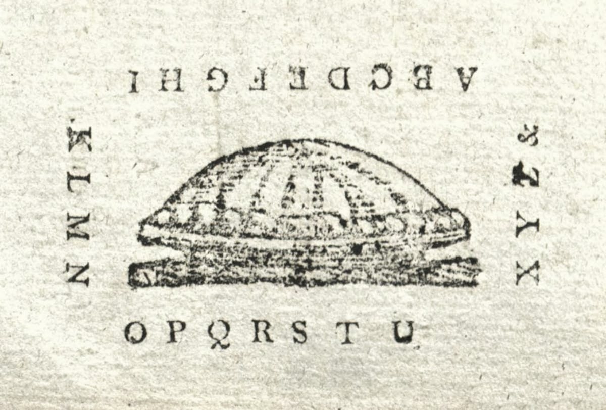 Woodcut of letters surrounding an apple pie