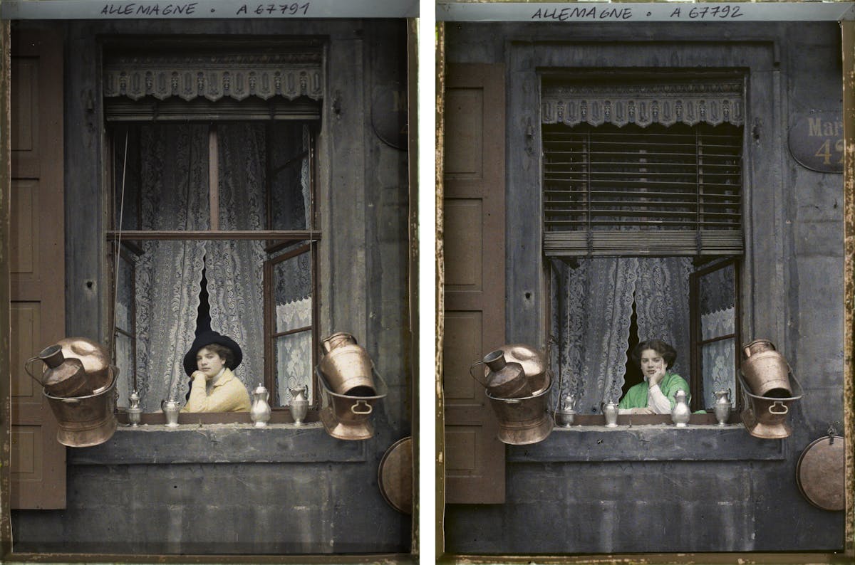 Two views of same scene showing young woman resting chin on hand while seated at window with ornate lace valance and curtains, surrounded by milk canisters and metal jugs, wearing different colored jackets but same contemplative expression.