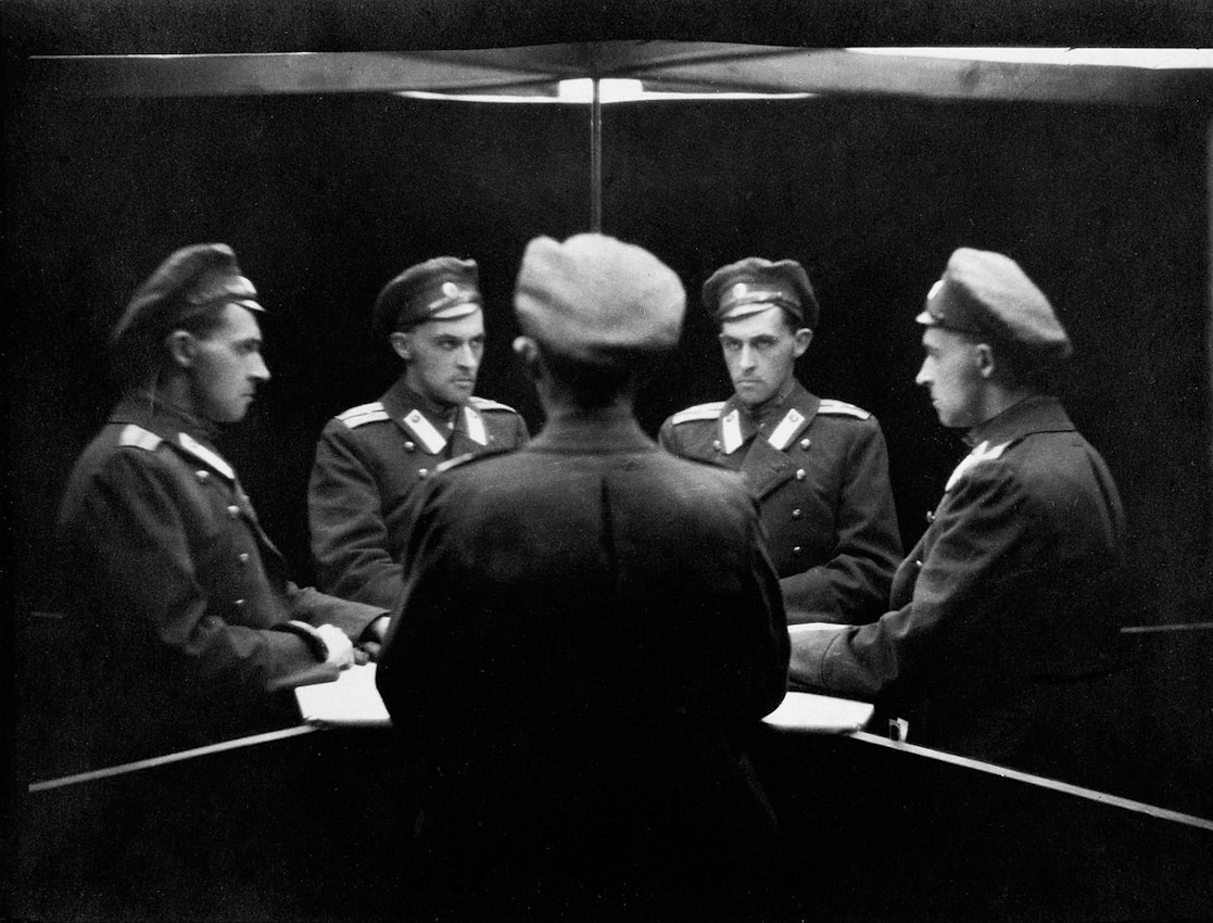 Witkiewicz is dressed in a military uniform and five repeated versions of himself stare at one another