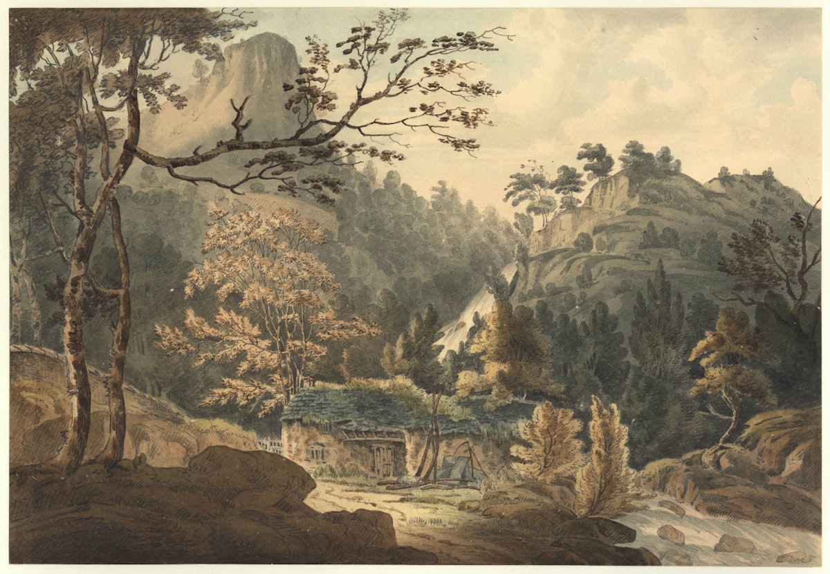 A small cottage surrounded by trees and mountains