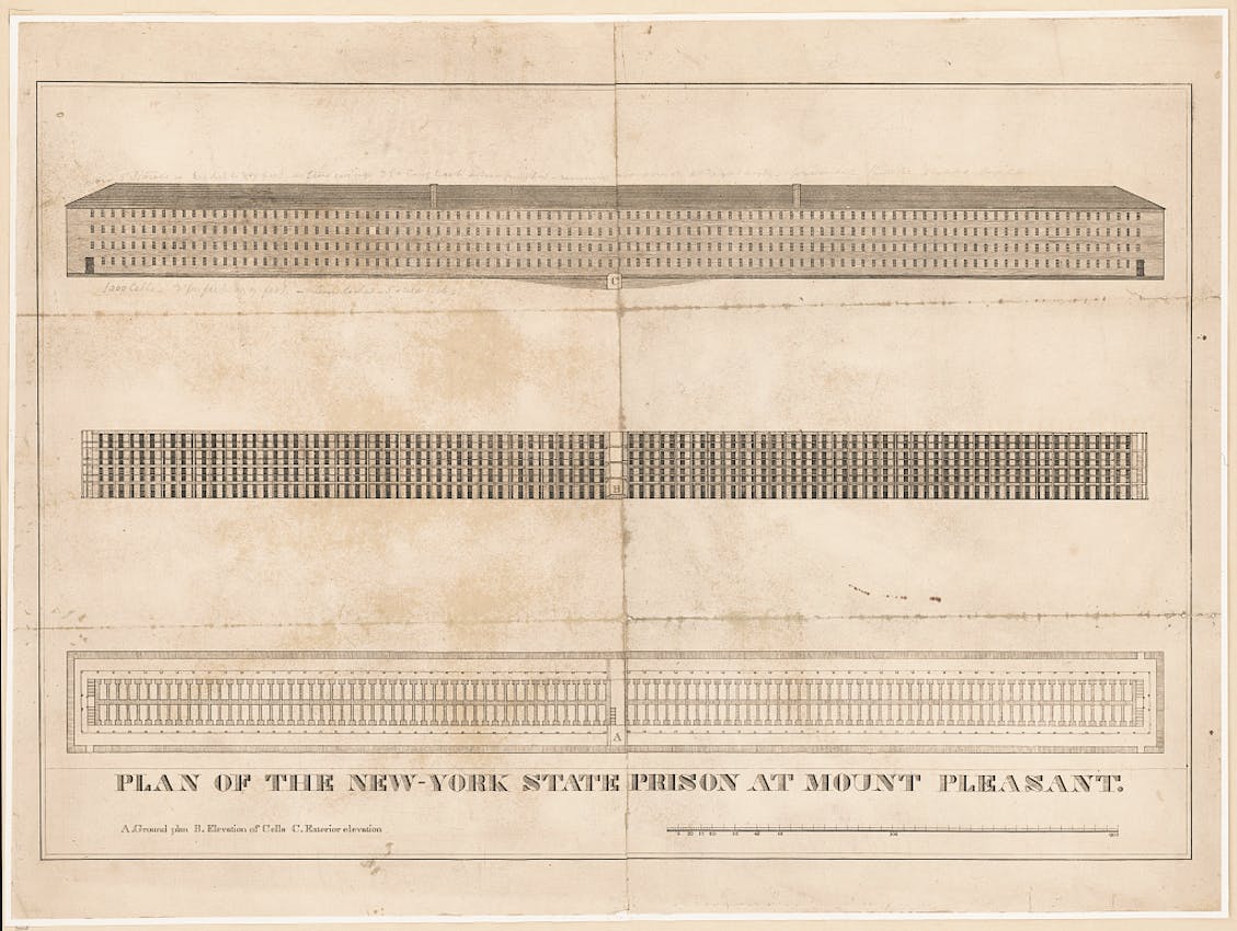 Architectural drawing showing three views of a long rectangular prison building with regular rows of windows and detailed floor plans.