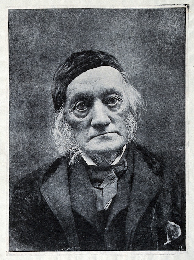 Portrait of a man with distinctive facial features and aged appearance wearing formal attire.