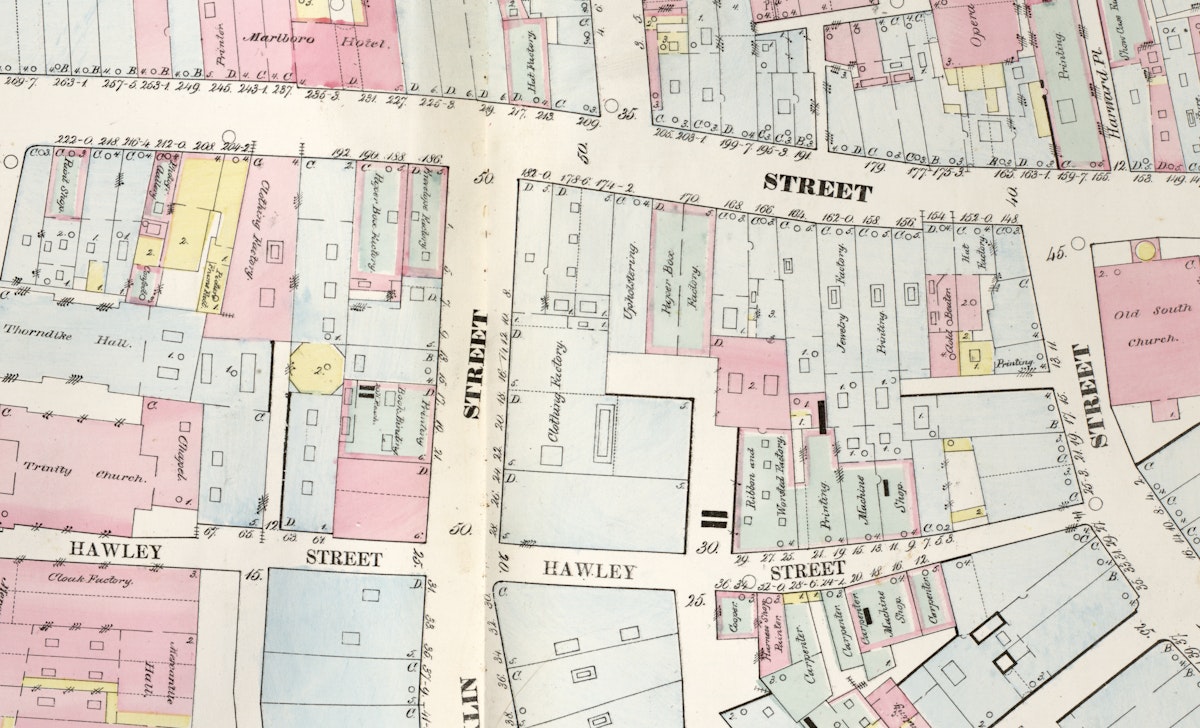 A close-up section of a map with color-coded buildings and streets, highlighting Hawley Street, a clothing factory, and Trinity Church.