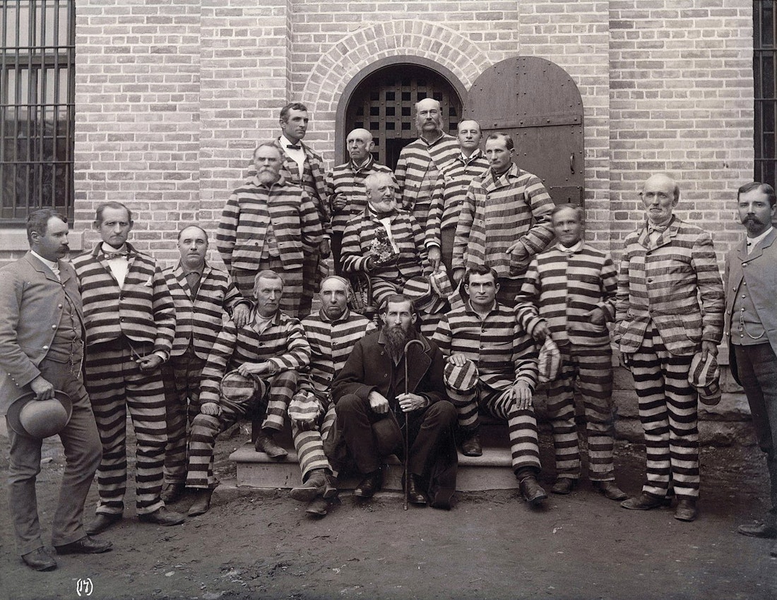 Men in striped prison uniforms