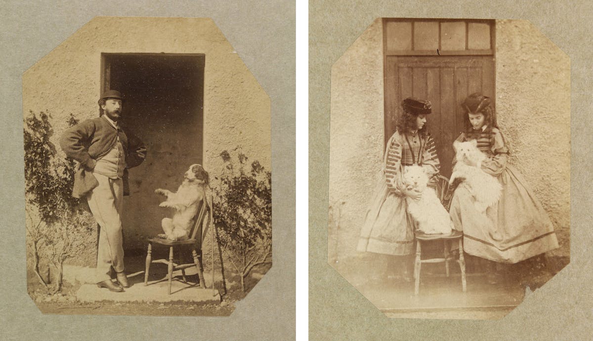 A pair of sepia-toned vintage photographs: the left image shows a man standing in a doorway, casually posed with one hand on his hip, next to a seated dog on a chair; the right image depicts two girls in striped dresses holding cats, also by a doorway. Both photos have octagonal cut edges.