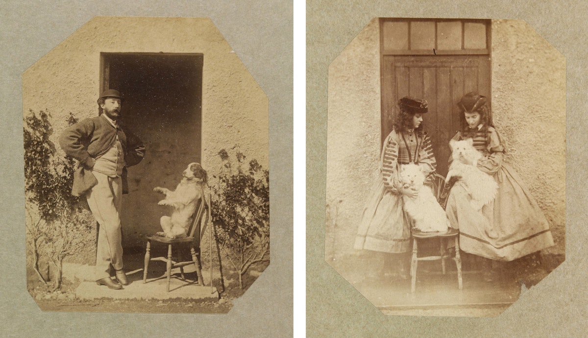 A pair of sepia-toned vintage photographs: the left image shows a man standing in a doorway, casually posed with one hand on his hip, next to a seated dog on a chair; the right image depicts two girls in striped dresses holding cats, also by a doorway. Both photos have octagonal cut edges.