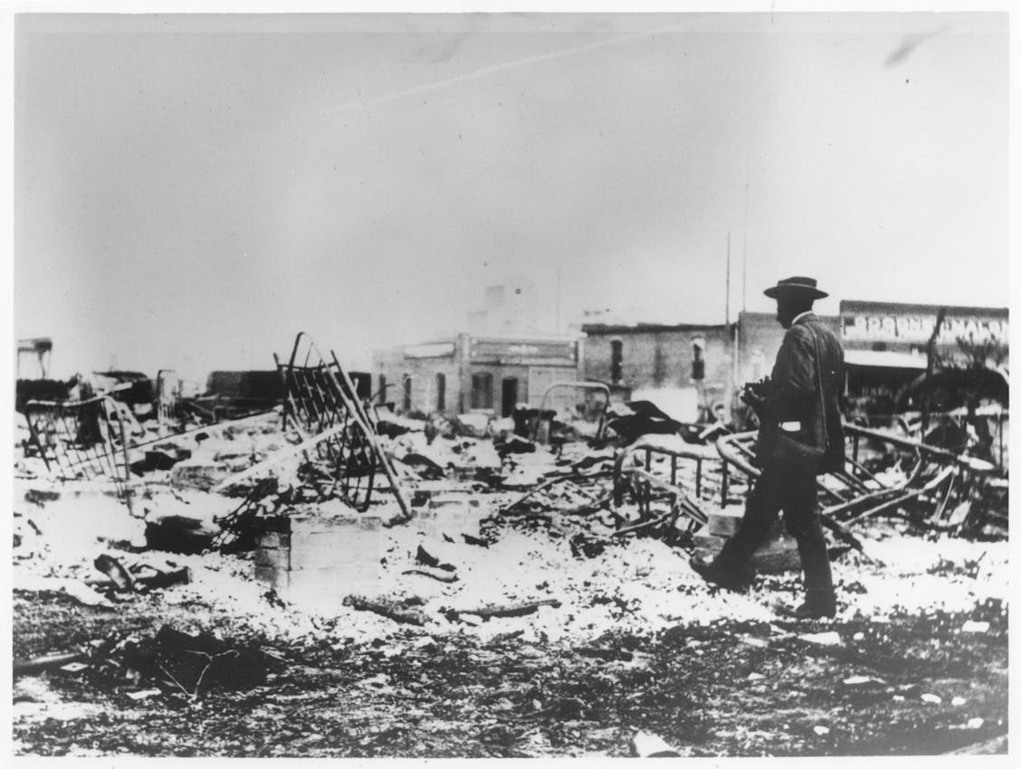 Man walking through rubble, tulsa massacre