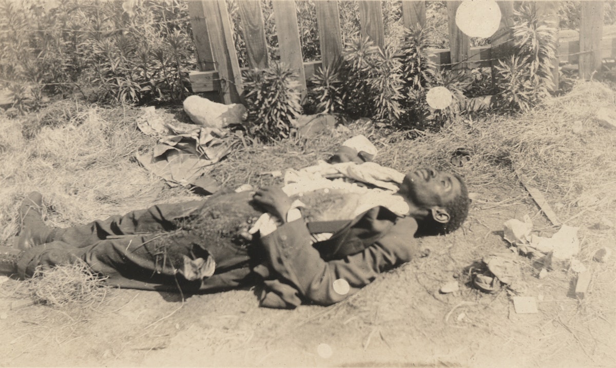 Dead Black man lying face-up on ground, tulsa massacre