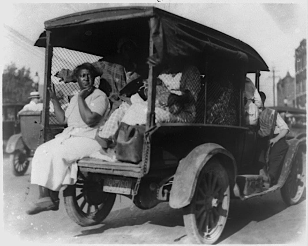 Woman sitting with legs swinging out of a truck