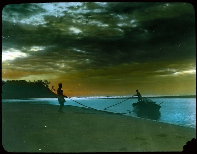 Two Men Landing Boat on Beach